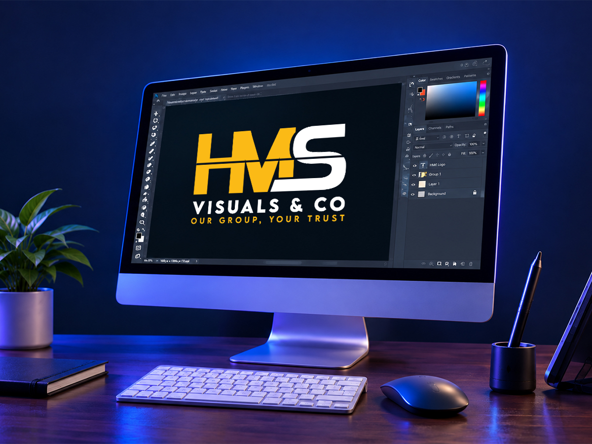 Design workstation with the HMS Visuals & Co. logo on the monitor